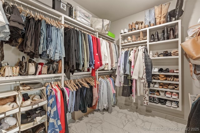 spacious closet featuring marble finish floor