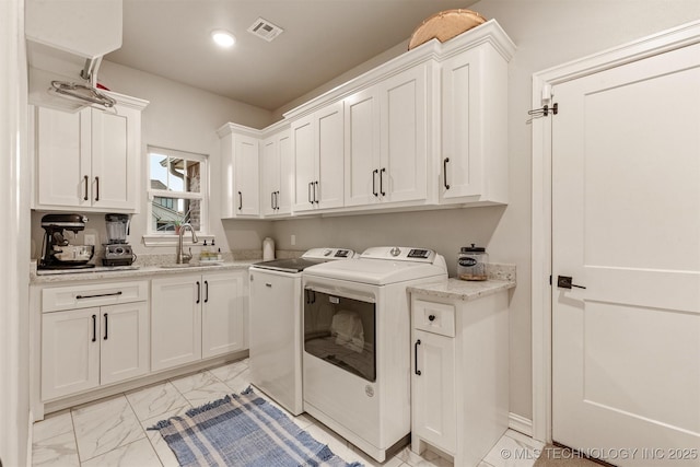 laundry room with washing machine and clothes dryer, visible vents, cabinet space, a sink, and marble finish floor