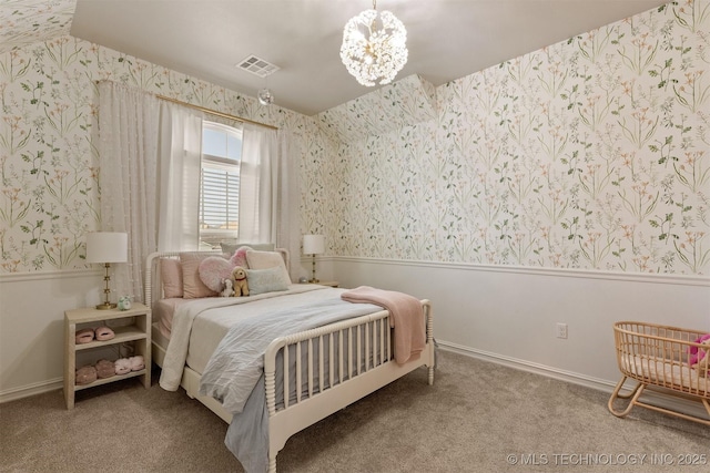 carpeted bedroom featuring wallpapered walls, visible vents, and a wainscoted wall
