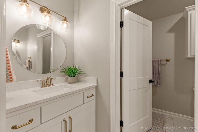 bathroom with baseboards, marble finish floor, and vanity