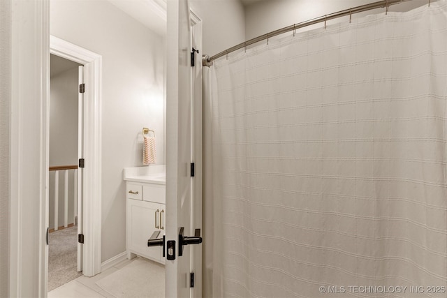 bathroom with vanity and baseboards