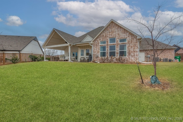 rear view of property with a yard, brick siding, fence, and central air condition unit