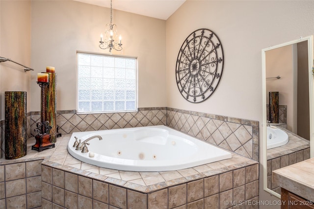 full bathroom featuring an inviting chandelier and a tub with jets