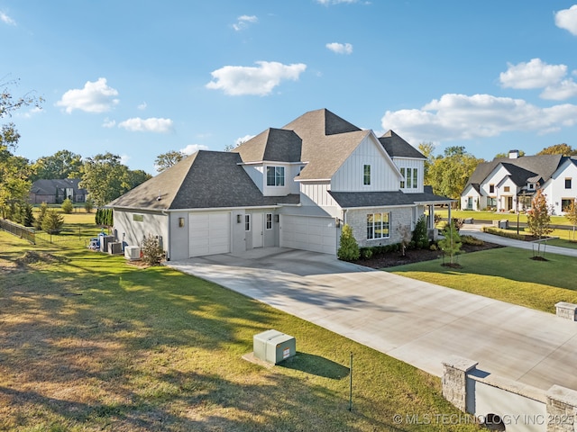 view of front facade with a garage, a front lawn, board and batten siding, driveway, and a residential view