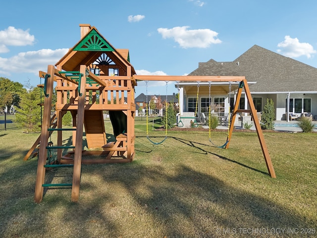 view of playground with fence and a yard