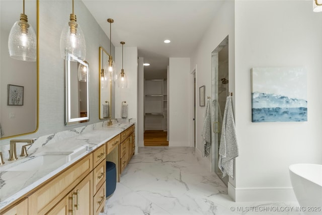 full bathroom featuring a freestanding bath, a sink, double vanity, recessed lighting, and a shower stall