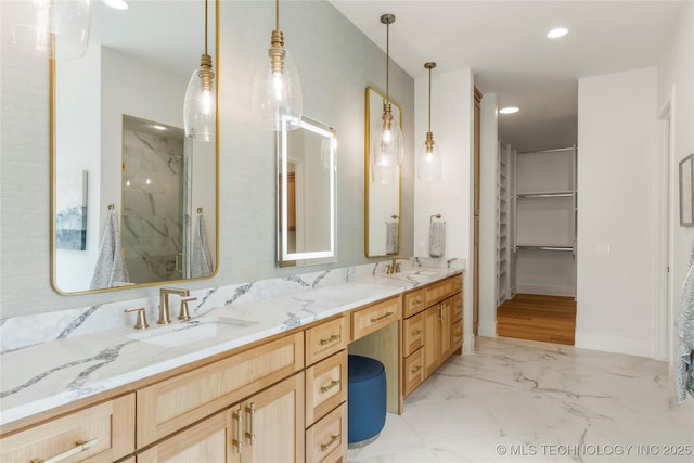 full bathroom featuring a sink, double vanity, a marble finish shower, marble finish floor, and recessed lighting