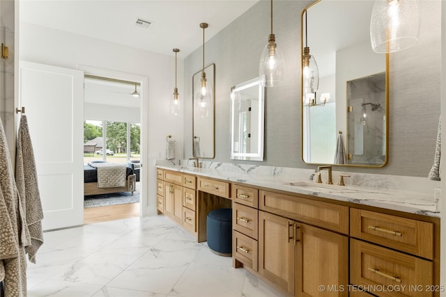 bathroom with double vanity, marble finish floor, a shower, a sink, and ensuite bath