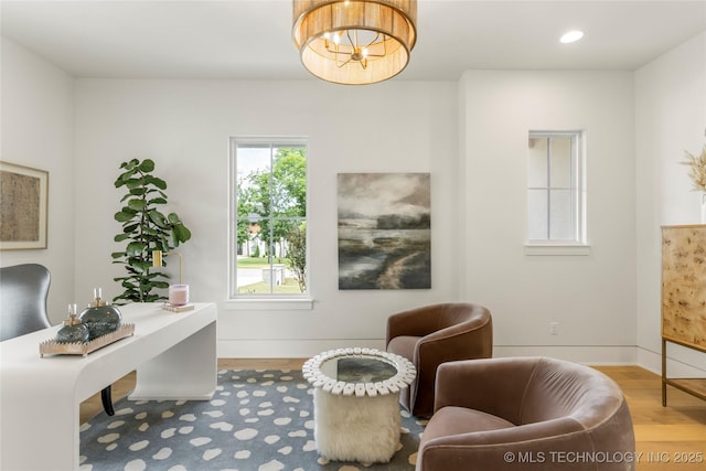 interior space featuring baseboards, recessed lighting, wood finished floors, and a notable chandelier