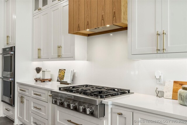 kitchen featuring light countertops, white cabinetry, and appliances with stainless steel finishes