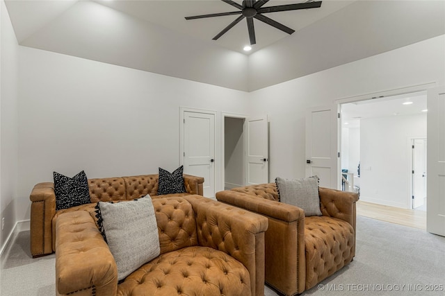 living area with ceiling fan, light colored carpet, high vaulted ceiling, baseboards, and recessed lighting