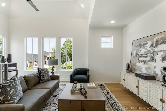 living room featuring a ceiling fan, baseboards, recessed lighting, and light wood-type flooring