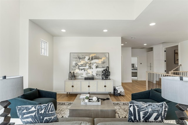 living area with recessed lighting and wood finished floors