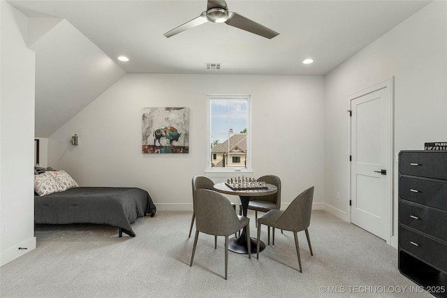 dining space with ceiling fan, visible vents, vaulted ceiling, baseboards, and light carpet