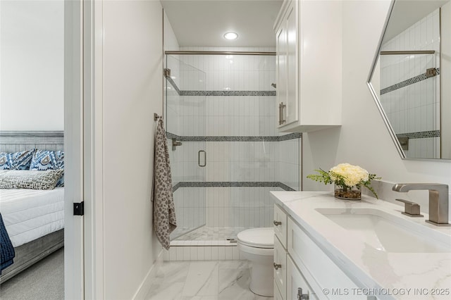 ensuite bathroom with connected bathroom, a shower stall, vanity, toilet, and marble finish floor