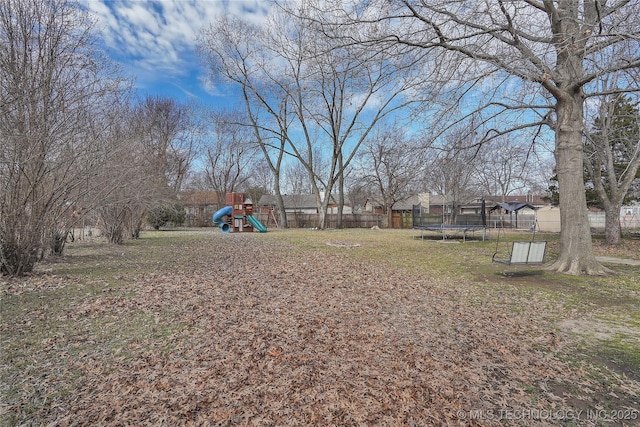 2918 S Ash Pl, Broken Arrow, OK 74012 - view of yard with fence, a trampoline, and a playground