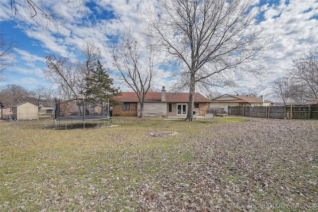 2918 S Ash Pl, Broken Arrow, OK 74012 - view of yard featuring a trampoline, fence, an outbuilding, and a shed