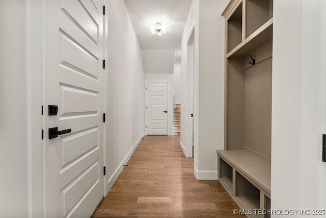 mudroom with light wood-type flooring and baseboards