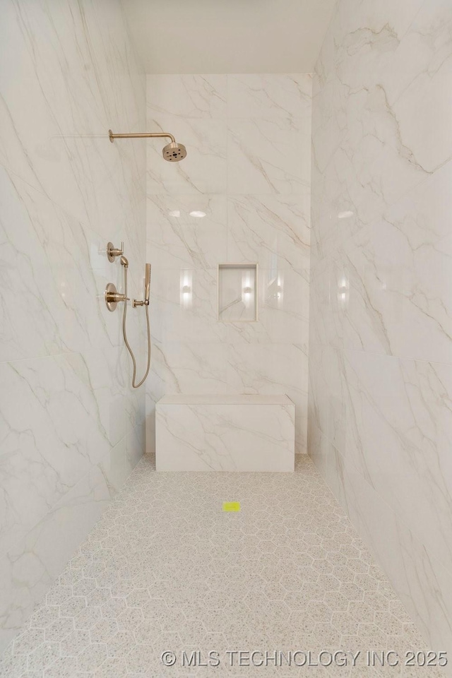 bathroom with a marble finish shower