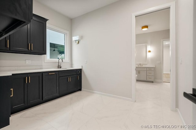 bathroom featuring vanity, baseboards, and marble finish floor