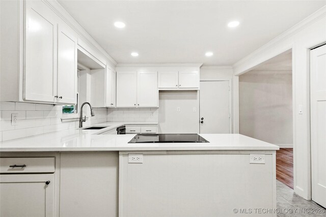 4814 E 37th St, Tulsa, OK 74135 - kitchen with white cabinets, black electric stovetop, a sink, a peninsula, and recessed lighting