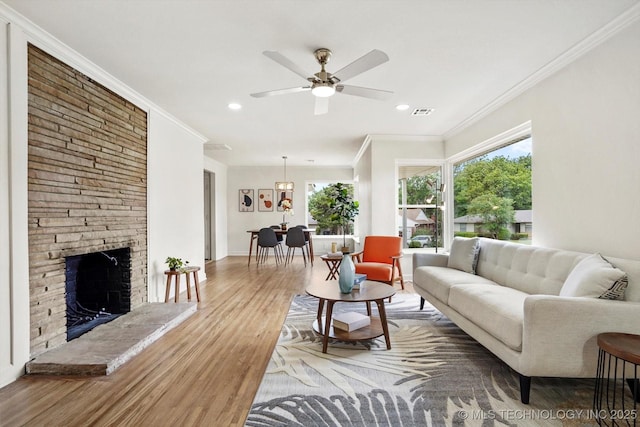 4814 E 37th St, Tulsa, OK 74135 - living room with wood finished floors, crown molding, recessed lighting, a ceiling fan, and a fireplace
