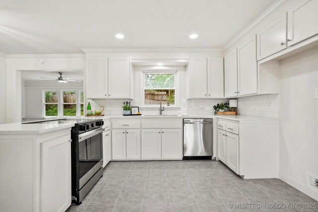 4814 E 37th St, Tulsa, OK 74135 - kitchen featuring stainless steel appliances, a sink, tasteful backsplash, a peninsula, and recessed lighting