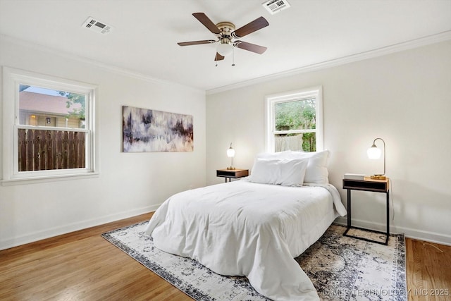 4814 E 37th St, Tulsa, OK 74135 - bedroom with crown molding, baseboards, wood finished floors, and ceiling fan