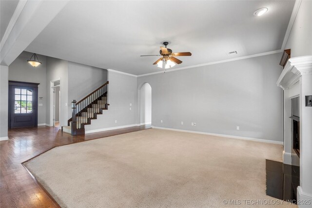 9502 S 73rd E Ave, Tulsa, OK 74133 - unfurnished living room with visible vents, stairs, baseboards, ceiling fan, and arched walkways