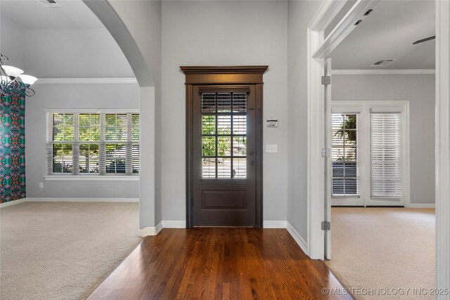 9502 S 73rd E Ave, Tulsa, OK 74133 - carpeted foyer with arched walkways, baseboards, ornamental molding, and visible vents