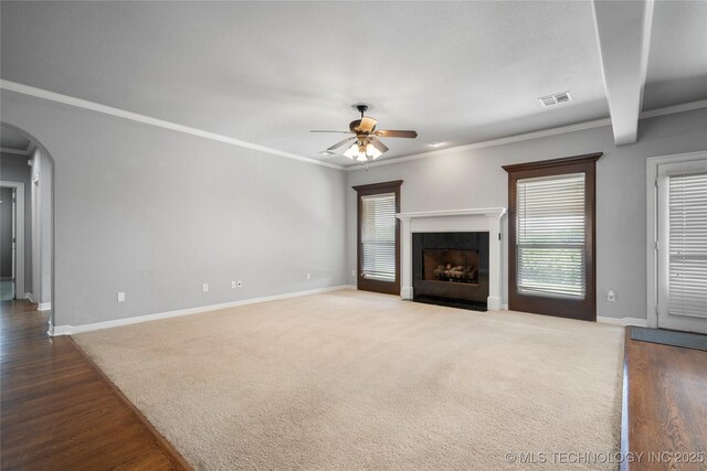 9502 S 73rd E Ave, Tulsa, OK 74133 - unfurnished living room featuring dark wood-style flooring, arched walkways, a ceiling fan, baseboards, and visible vents