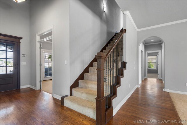 9502 S 73rd E Ave, Tulsa, OK 74133 - entrance foyer with arched walkways, baseboards, wood finished floors, and stairway
