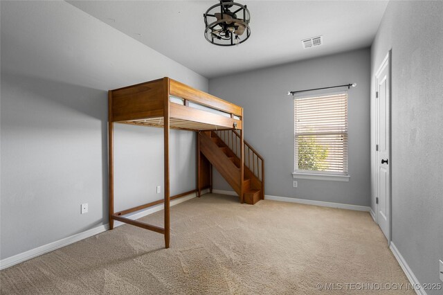 9502 S 73rd E Ave, Tulsa, OK 74133 - unfurnished bedroom with visible vents, baseboards, carpet floors, and a chandelier