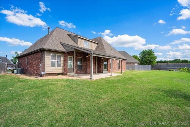 9502 S 73rd E Ave, Tulsa, OK 74133 - back of property with a fenced backyard, brick siding, a shingled roof, a patio area, and a yard