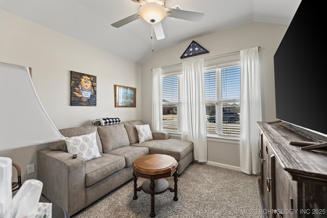living area featuring baseboards, light carpet, a ceiling fan, and lofted ceiling
