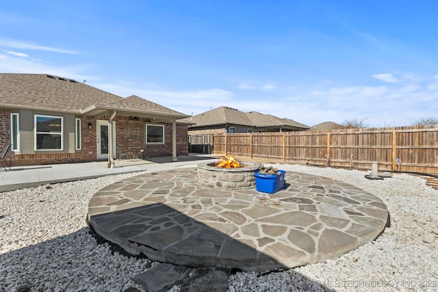 view of patio / terrace with a fenced backyard and an outdoor fire pit