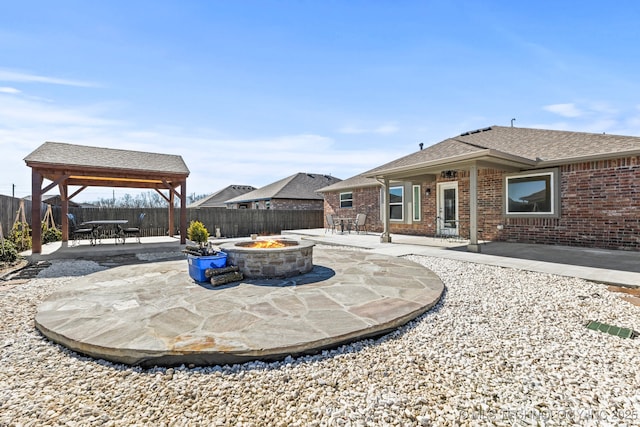 view of patio / terrace with a fenced backyard, a gazebo, and a fire pit