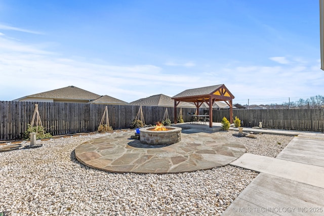 view of patio / terrace featuring a fenced backyard, a gazebo, and a fire pit