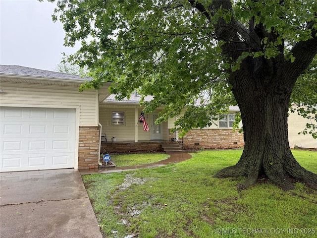 116 S Camden St, Muskogee, OK 74403 - view of front of home featuring a front yard, concrete driveway, a garage, brick siding, and crawl space