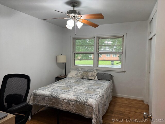 116 S Camden St, Muskogee, OK 74403 - bedroom with wood finished floors, baseboards, and ceiling fan