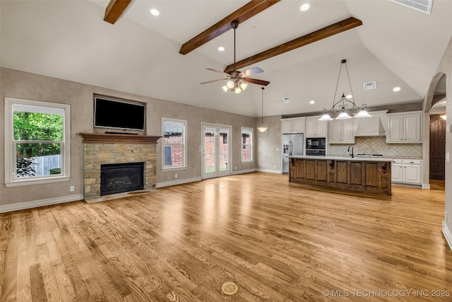 kitchen featuring a ceiling fan, light countertops, black appliances, open floor plan, and white cabinetry