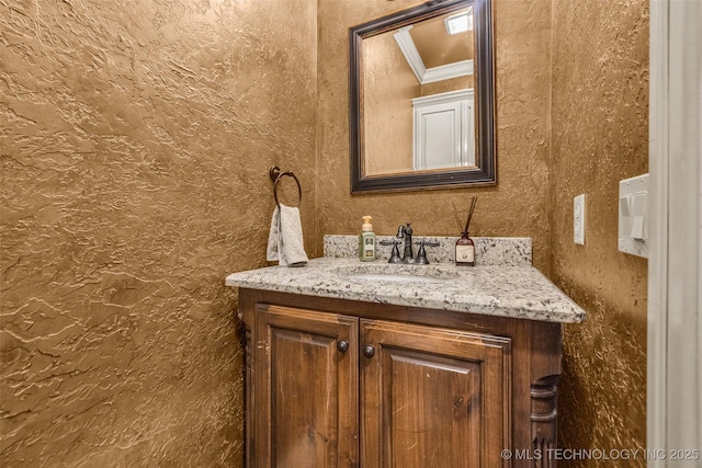bathroom with vanity and crown molding