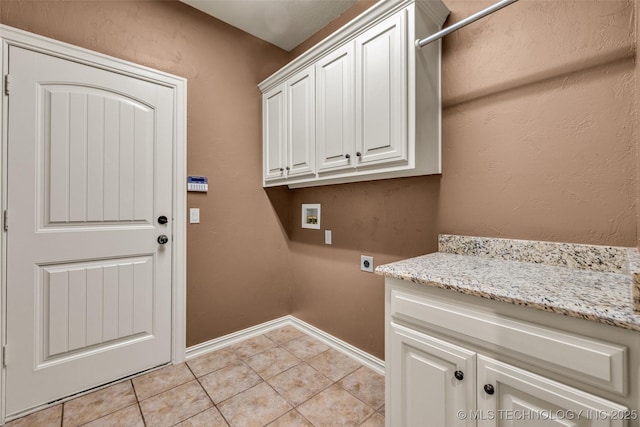 laundry area featuring baseboards, hookup for a washing machine, electric dryer hookup, cabinet space, and light tile patterned floors
