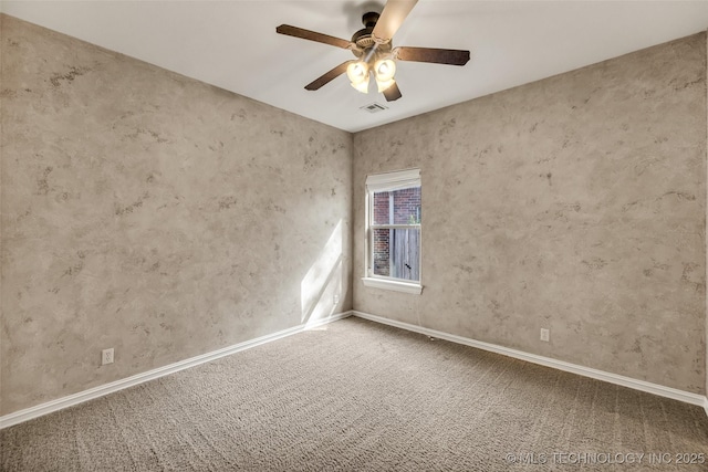 empty room with baseboards, ceiling fan, carpet, and visible vents