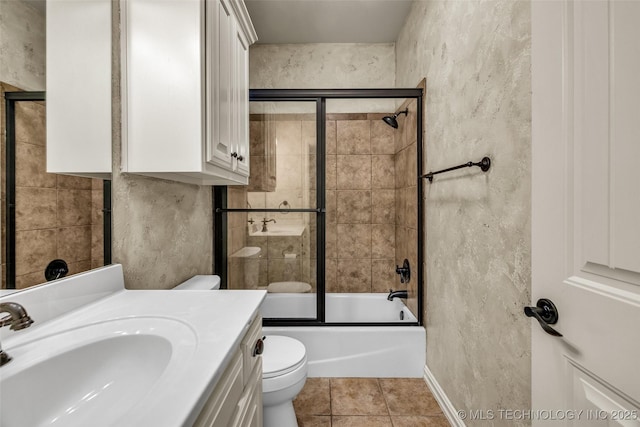 bathroom featuring a textured wall, tile patterned flooring, vanity, toilet, and enclosed tub / shower combo