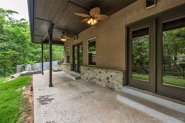view of patio / terrace featuring fence and a ceiling fan