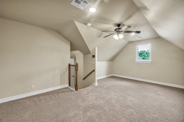 bonus room featuring carpet, a ceiling fan, baseboards, lofted ceiling, and visible vents
