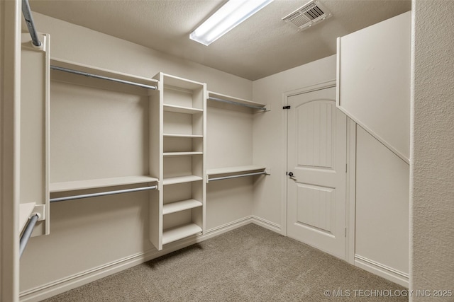 walk in closet featuring carpet flooring and visible vents