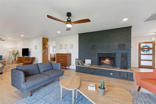7207 E 166th St, Collinsville, OK 74021 - living room featuring a ceiling fan, a fireplace, wood finished floors, recessed lighting, and baseboards