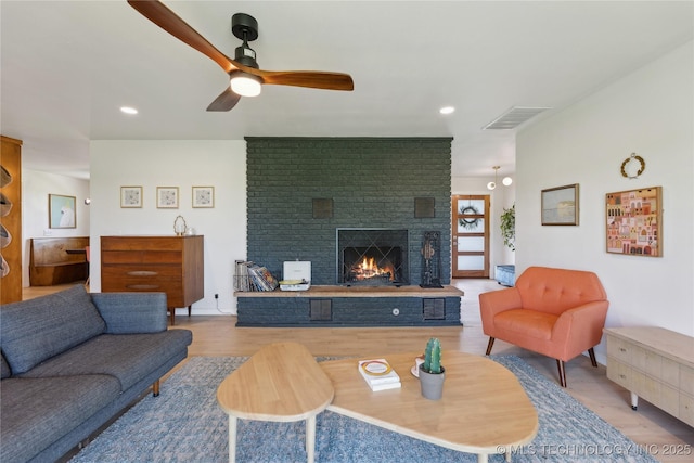 7207 E 166th St, Collinsville, OK 74021 - living room with a brick fireplace, a ceiling fan, wood finished floors, and recessed lighting